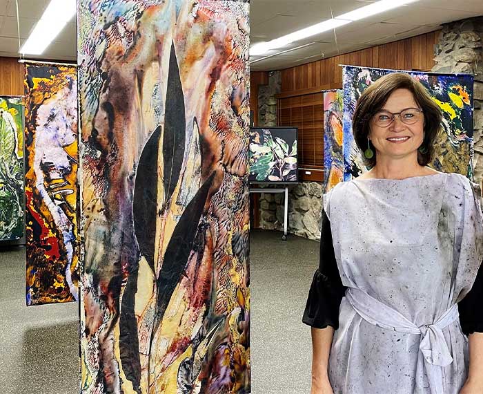 Image of artist with works in studio