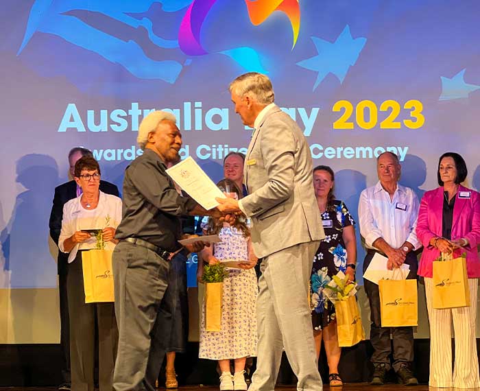 Image of Mayor presenting certificate to new citizen