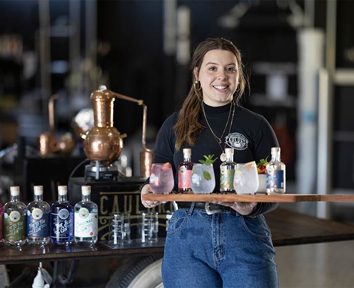 Image of waitress with tray of gin tastings